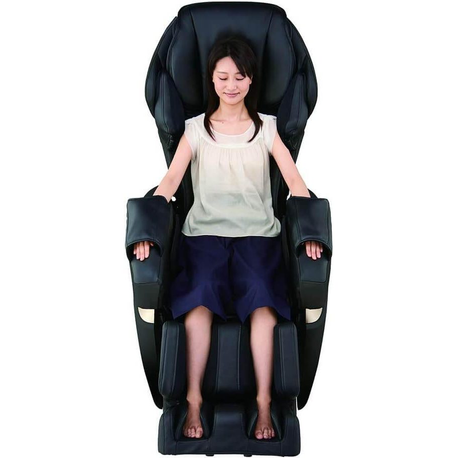 Woman enjoying full body massage in Synca Wellness Kurodo Massage Chair with black leather upholstery