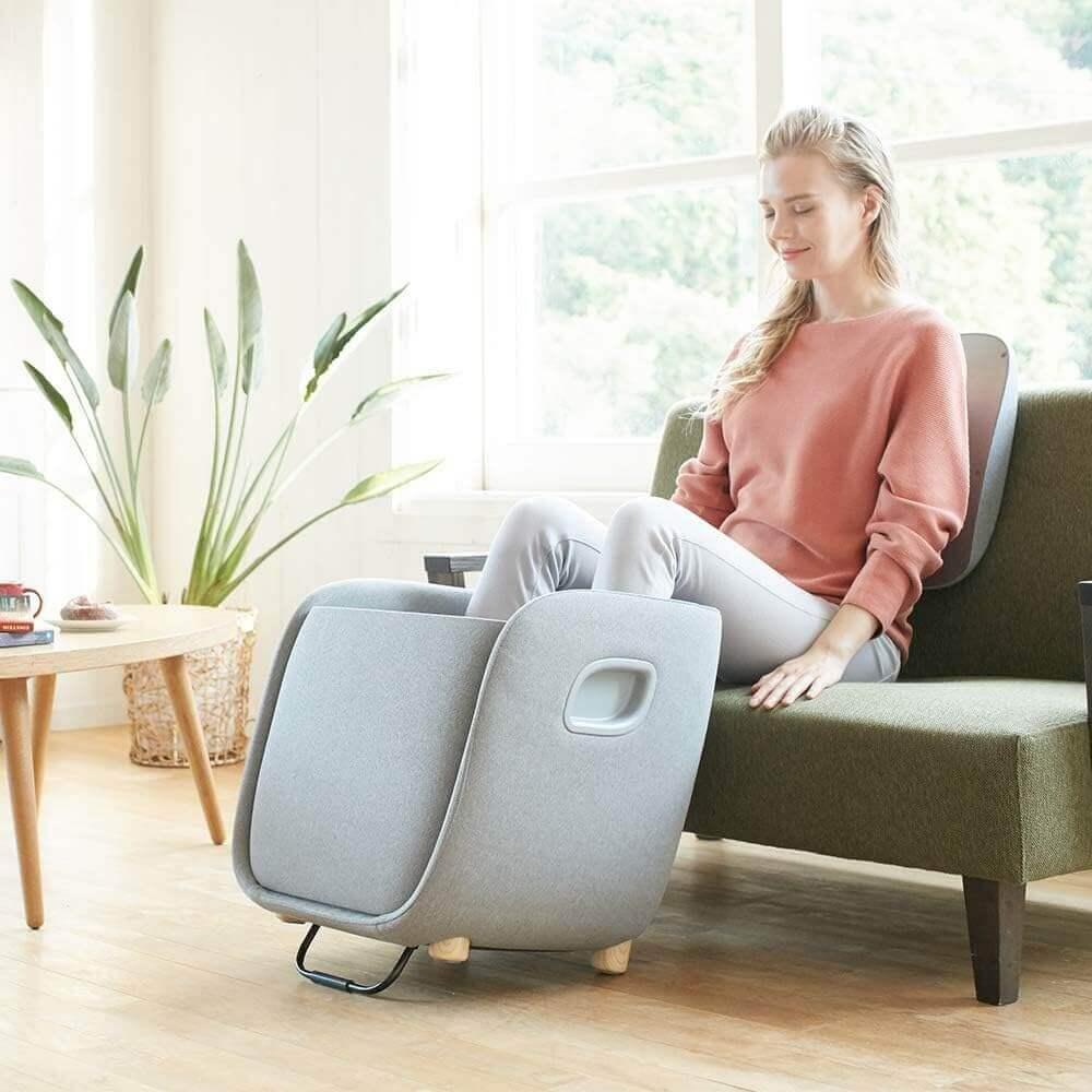 Woman using Synca Wellness REI Foot Massager electric massager at home for foot relaxation