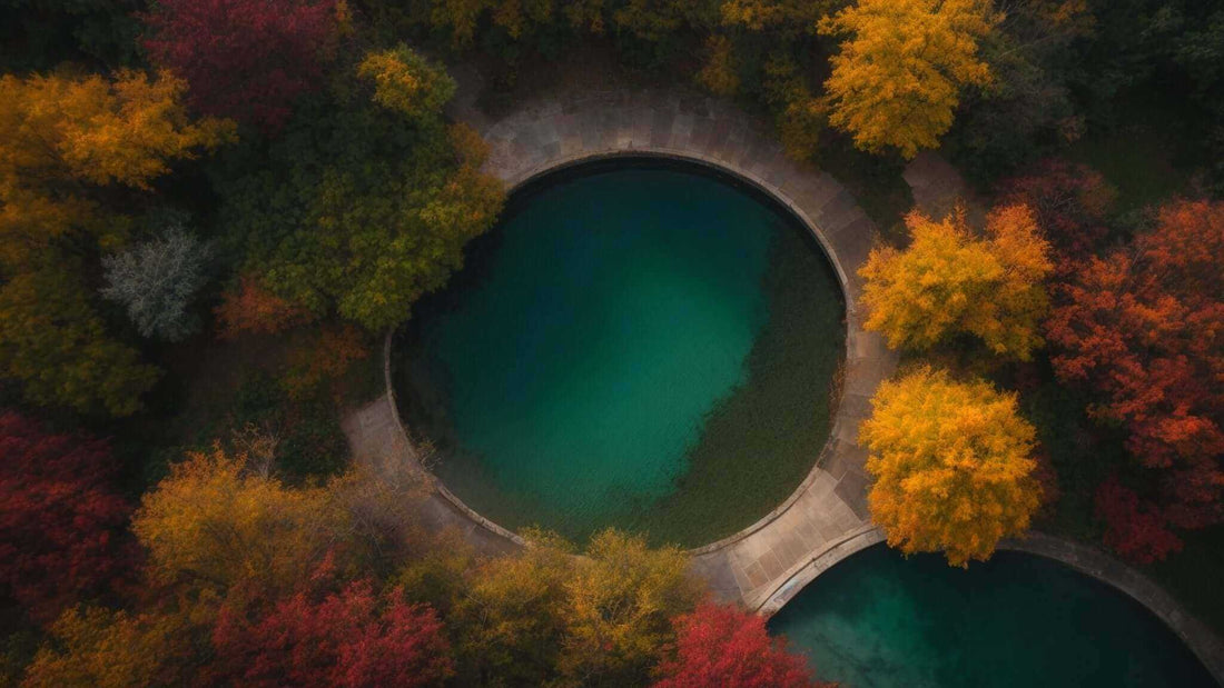 Scenic aerial view of two circular water features surrounded by vibrant autumn foliage highlighting key features of full body massage chairs