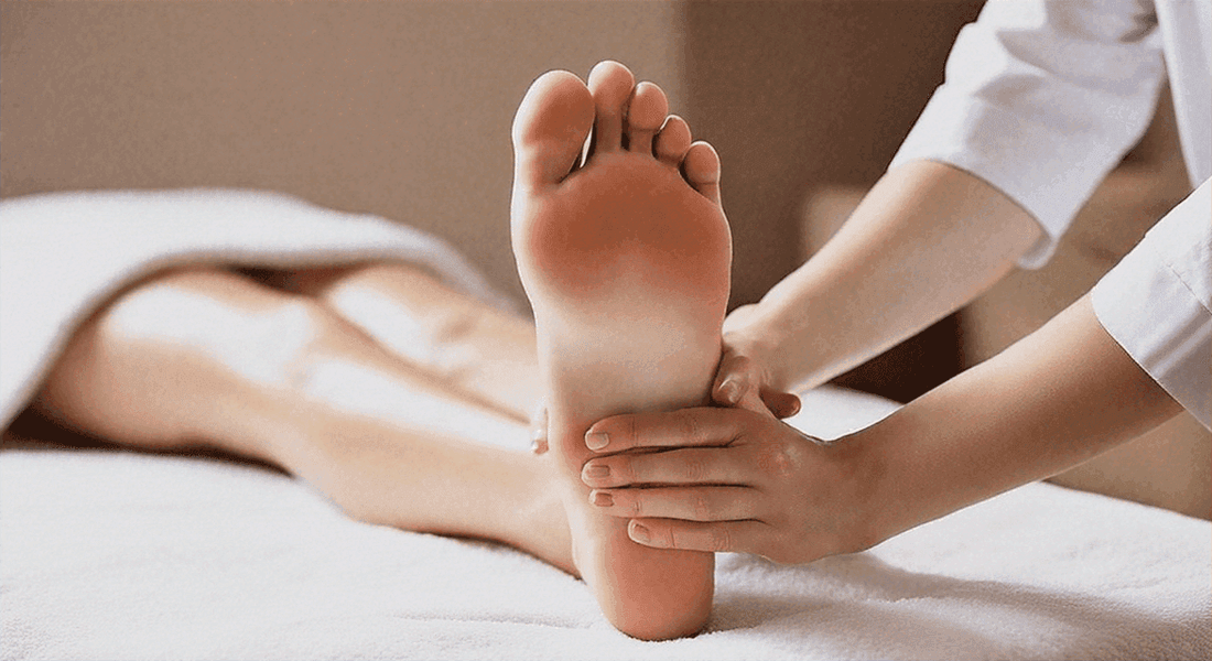Foot massage shows bare feet with hands gently holding the sole and heel during treatment; Choosing the Perfect Foot Massager: Features to Look For