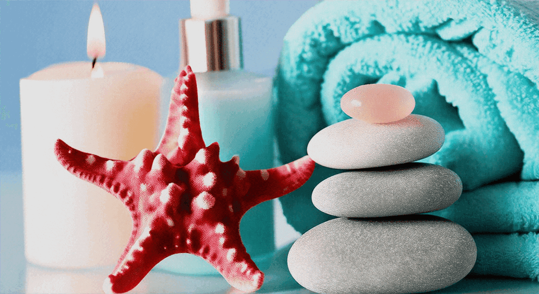 Experience the Best in Relaxation: Fujiiryoki Massage Chair Breakdown beside stacked smooth stones, a red starfish and spa candle