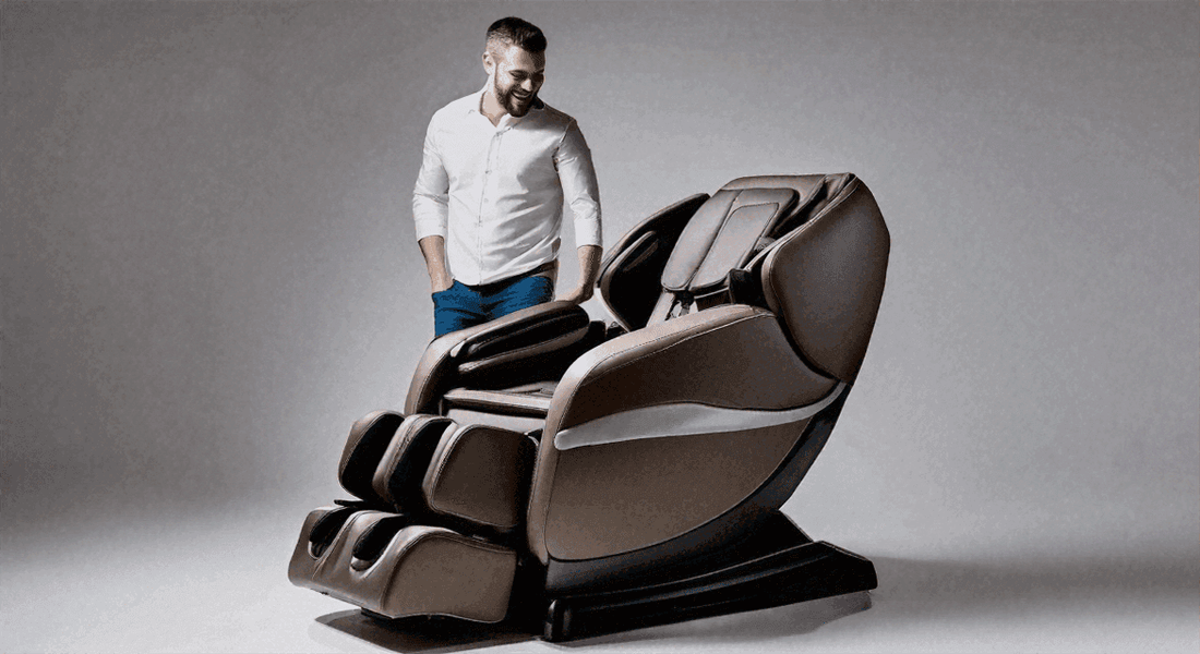 Massage chair in dark brown and black leather with padded contours and an extended footrest, beside a man