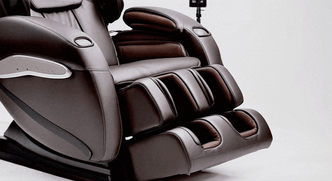 Massage chair in dark brown leather with padded armrests and segmented reclining leg and foot rests; Unlock the Benefits: Massage Chairs Features & Benefits Explained