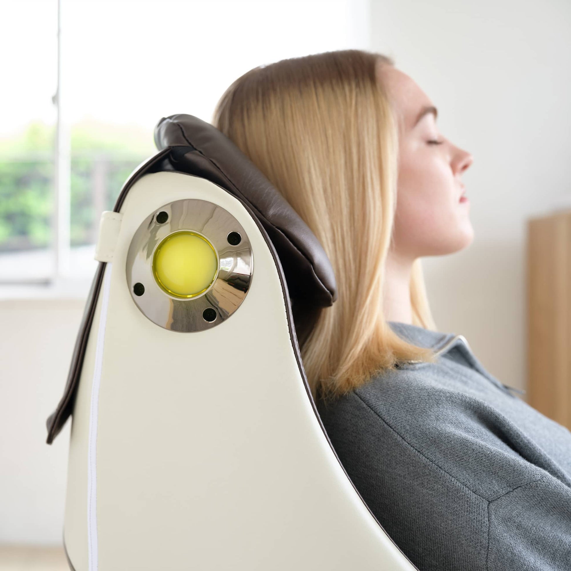 Woman relaxing in a Synca Wellness CirC Massage Chair with ergonomic design and soothing features