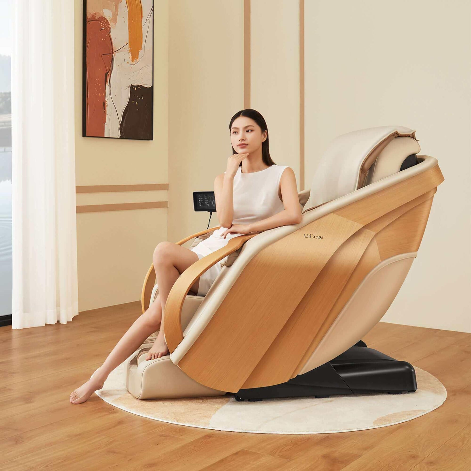 DCore 2 electric massaging chair in beige with wooden accents and a woman seated in a modern living room