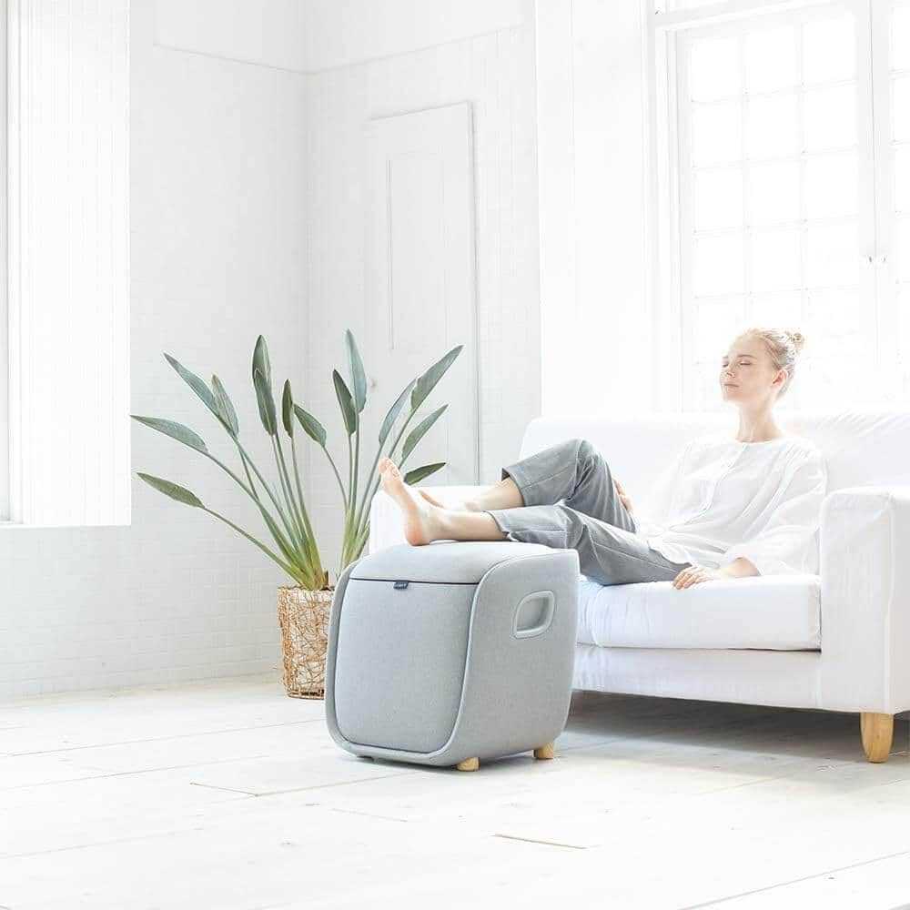 Foot + Calf + Lumbar Ottoman Massager in light gray fabric, with a rounded ottoman design and integrated foot compartment