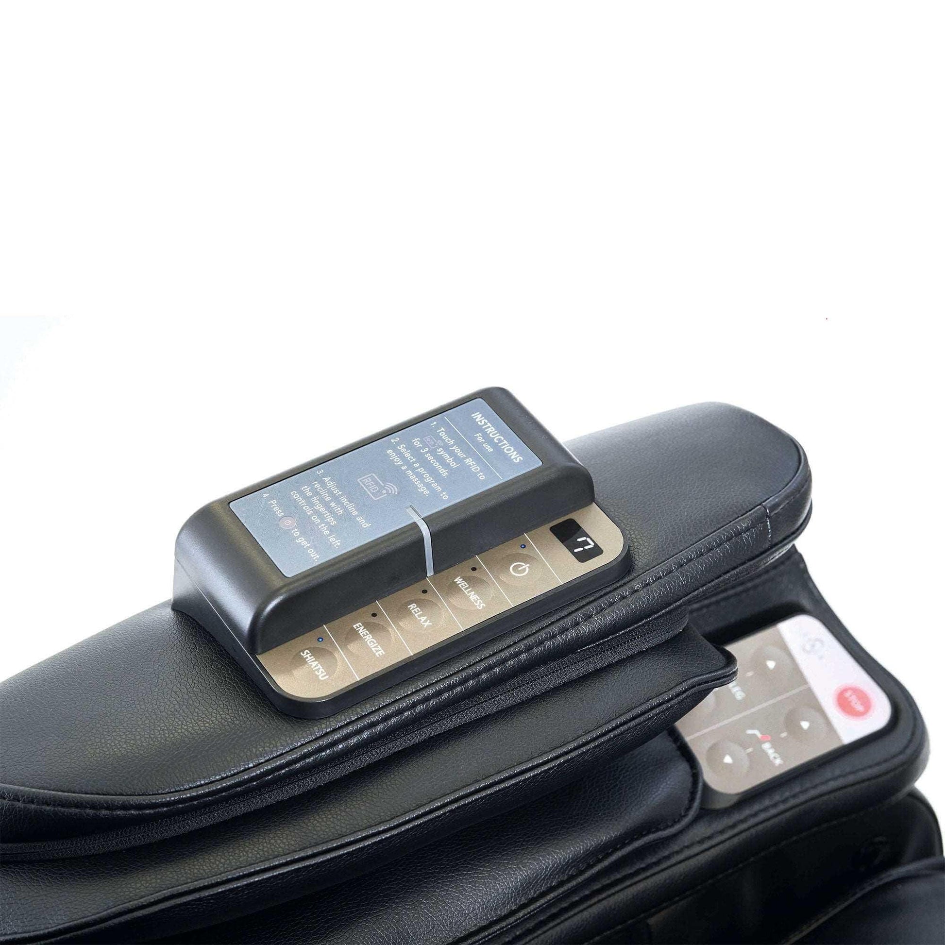Synca Wellness commercial massage chair remote resting on black leather electric massaging chair arm