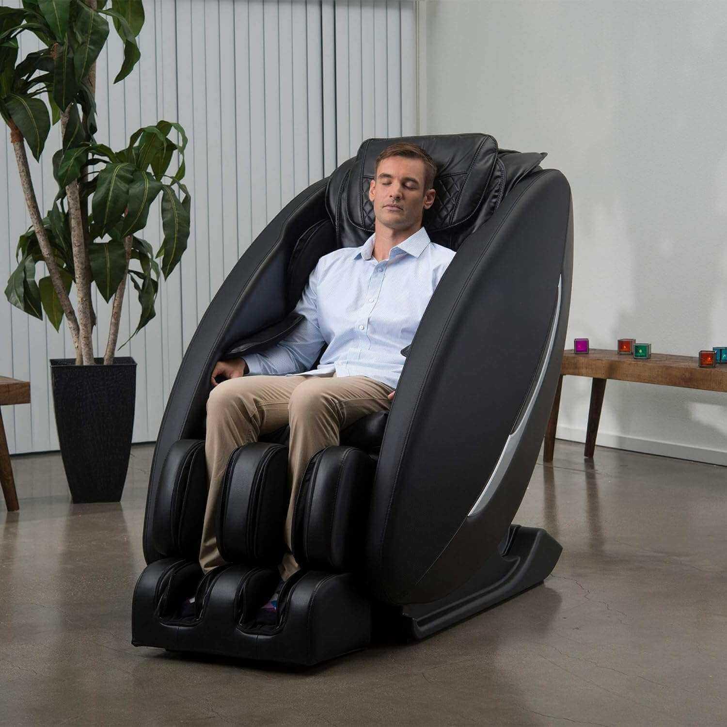 Inner Balance Ji Massage Chair in black with man enjoying full body electric massage