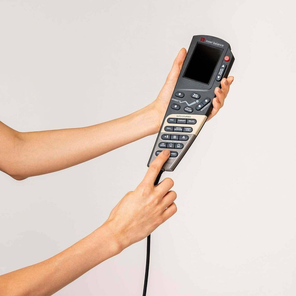 Jin 2 Massage Chair wired remote control with a black screen and silver buttons, held in two hands