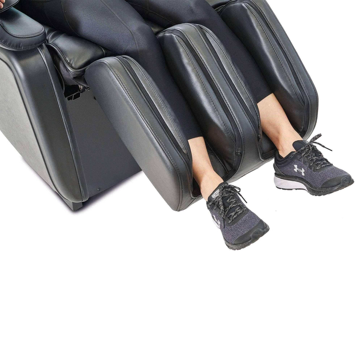Kurodo E commercial massage chair with black padded leg and calf compartments enclosing a seated user's lower legs