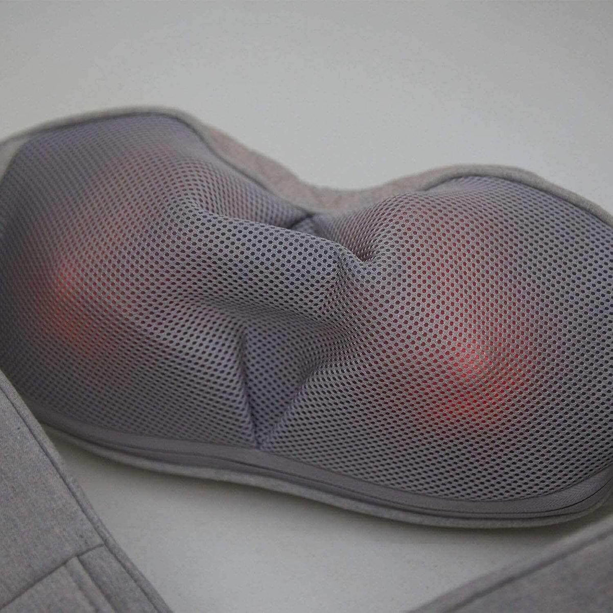 Neck and Shoulder Massager in gray mesh fabric with contoured padded sections and visible red heat elements