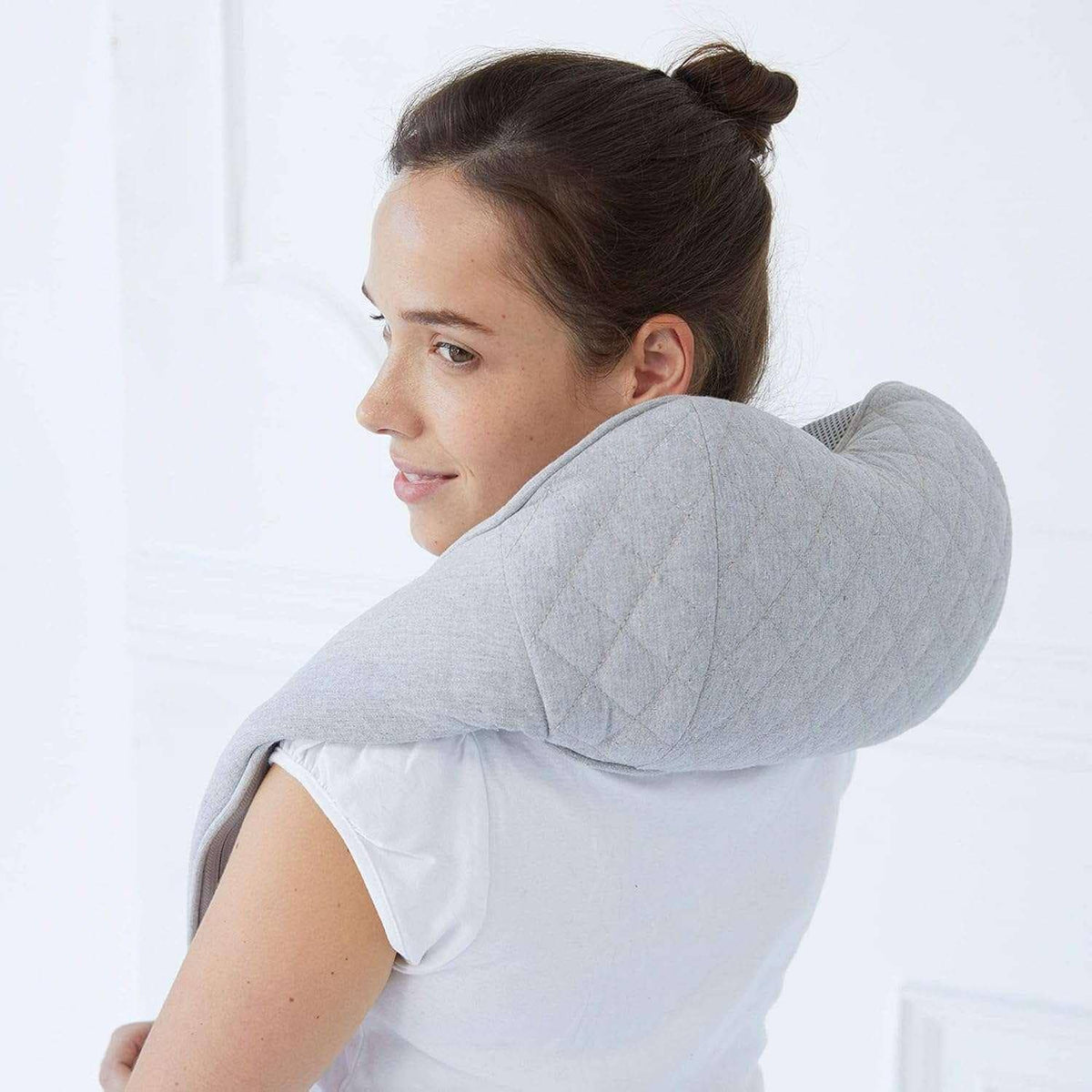 Neck and Shoulder Massager in light gray quilted fabric, worn around the neck with a cushioned wraparound design